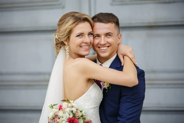 Wedding couple, portrait of happy bride and groom on background with copy space. Young and...