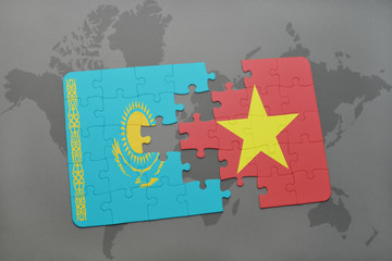 puzzle with the national flag of kazakhstan and vietnam on a world map