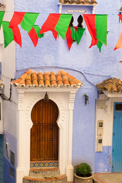 Africa, Morocco, Chefchaouen or Chaouen  is the chief town of the province of the same name. Moroccan red and green flags/banners fly vilage square.