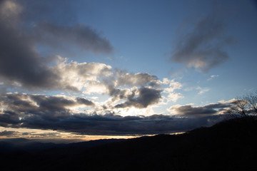 Naklejka na ściany i meble Cloudy Sunset in the Mountains
