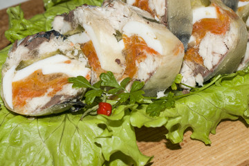 Roll of mackerel with vegetables on a wooden Board