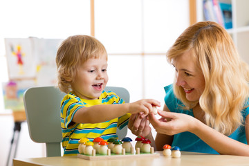 Mother and child learn color, size, count while playing with developmental toys. Early education...