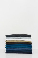 stack of t-shirt on white background, copy space