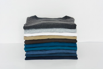 stack of t-shirt on white background, copy space