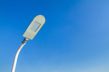 The street light lamp save energy pole with a blue sky backgroun