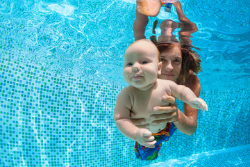 Family fitness - father hold in hands baby son learning swim, dive underwater with fun in pool. Active parent lifestyle, water sport activity, weekend aqua classes, children swimming lesson.