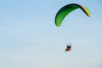 Paramotor, Parachute, Paraglide flying in the sunset sky
