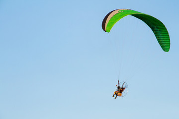 Paramotor, Parachute, Paraglide flying in the sunset sky