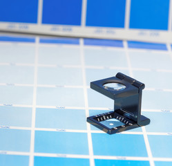 Magnifier or printer's loupe sits on a cyan test sheet