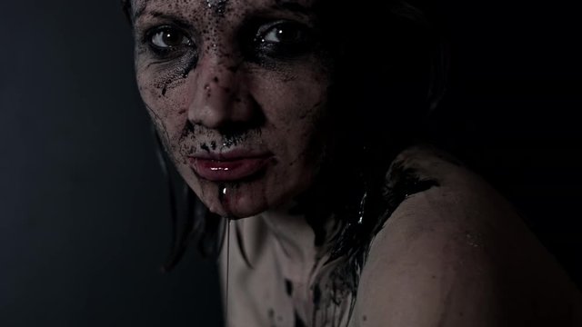 4k shoot of a horror Halloween model spitting black water from mouth