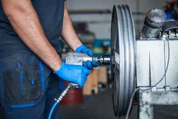 Mechanic fixing a compressor engine