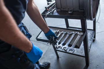 Mechanic tidying up tools
