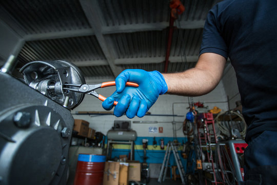 Mechanic fixing a compressor engine