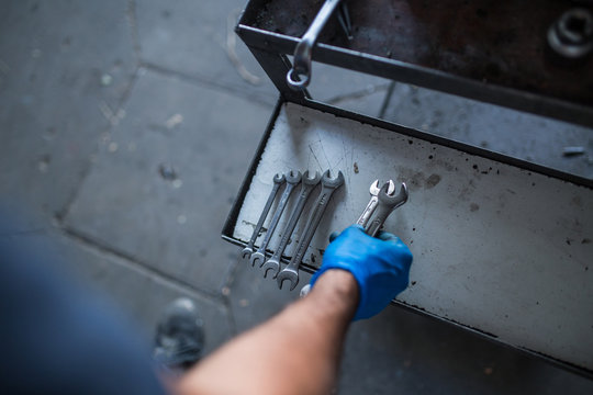 Mechanic tidying up tools