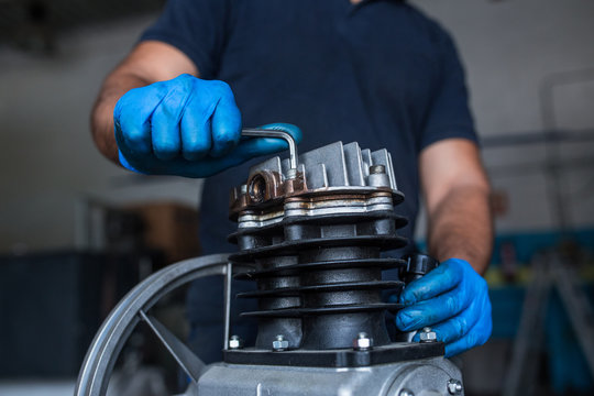 Mechanic fixing a compressor engine