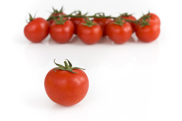 Bunch of cherry tomatoes on white background. Still-life picture taken in studio with soft-box.