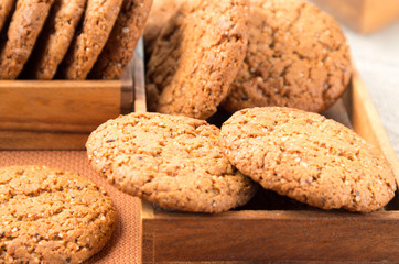 Many of oatmeal cookies in two wooden boxes