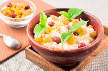 View close-up on oatmeal with raisins and berries