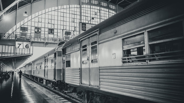 Fototapeta Arrival train at railway station or train station with structure and roof in Bangkok, Thailand.