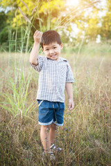 Happy little asian boy playing outdoors. Enjoy life. Cute asian