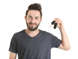 Portrait of young man holding car key, isolated on white