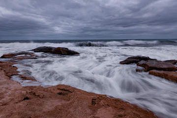 Cloudy dramatic sky, big waves, cloudscape just before the storm near the shore