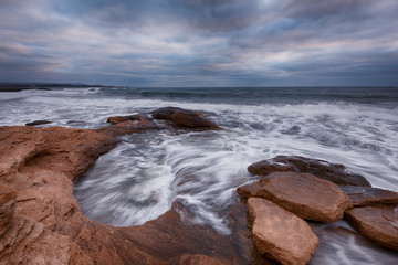 Cloudy dramatic sky, big waves, cloudscape just before the storm near the shore