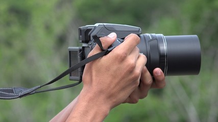 Teen Boy Learning To Use Digital Camera