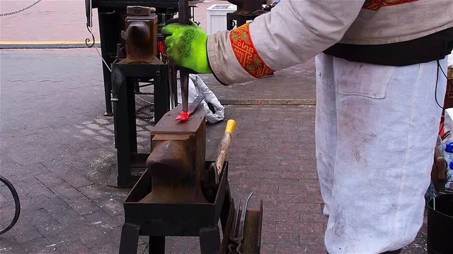 Modern blacksmith in capital demonstrates their ability to manufacture fasteners at Christmas fair