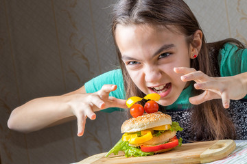 girl eagerly pounced on a hamburger, holding out her arms to him with a crooked fingers