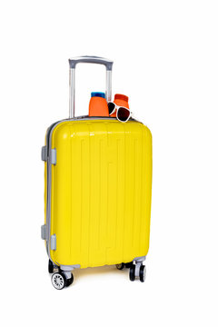 Travel yellow bag and cosmetics on white background.