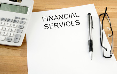 Financial Services with pen and calculator