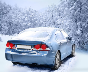 Car on winter landscape background