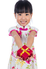 Asian Chinese little girl wearing cheongsam holding gift box