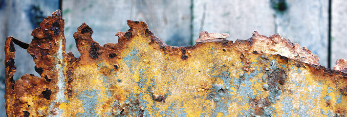 old and rusty metal corrosion and cracked paint on it