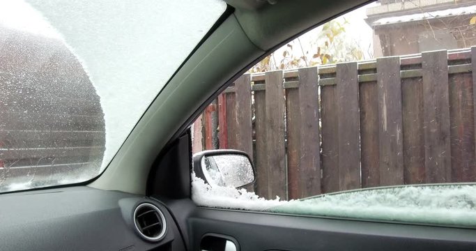 Color footage from inside a car, with side window opening, during a snow storm.