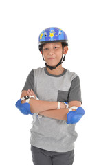 Happy Asian boy wearing safety guard for playing roller blades o