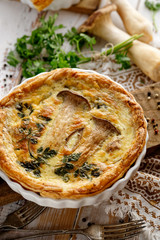 Mushroom quiche on a wooden table, top view