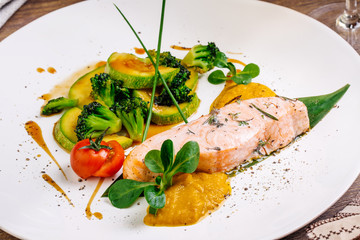 grilled salmon steak on a round white plate