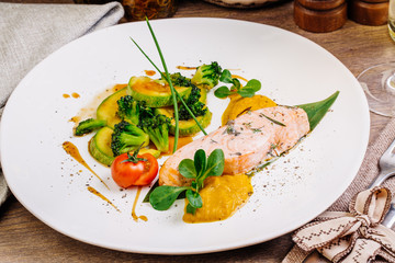 grilled salmon steak on a round white plate