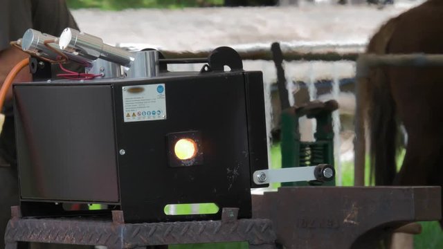 Farriers mobile gas forge gives off heat haze at outdoor craft fair