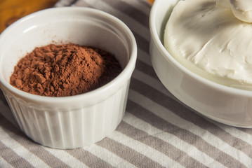 Cocoa powder and mascarpone cheese in bowls