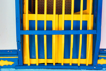 wooden colourful colombian window security bar closeup