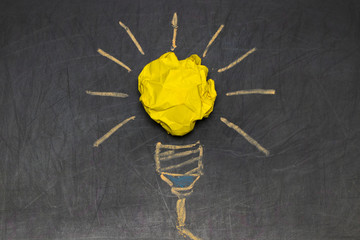 Inspiration concept crumpled color paper light bulb metaphor