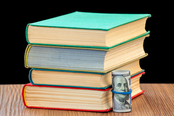 The pile of books and dollars in a tubule.