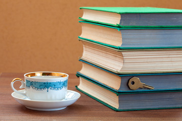 book firm cover  with a cup on a wooden table.