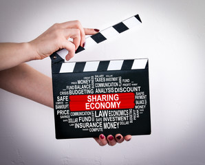 Sharing economy Concept. Female hands holding movie clapper. 