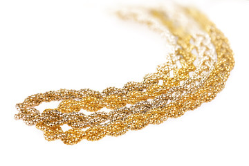 Close-up of two different types and colors of a golden metallic headbands made of multiple weaved golden fibers, fashion item isolated on white background