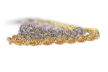 Close-up of two golden and silver metallic headbands made of multiple weaved golden and silver  fibers, very shallow depth of field and low perspective, fashion item isolated on white background