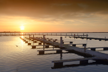 Naklejka premium Yacht port over orange sunset